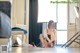 A woman sitting on the floor in a room.