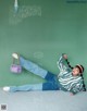 A woman laying on the ground with a purple bag.